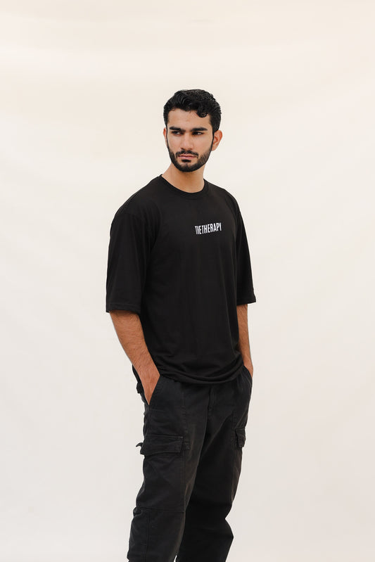 Man wearing a black t-shirt and pants on a white background